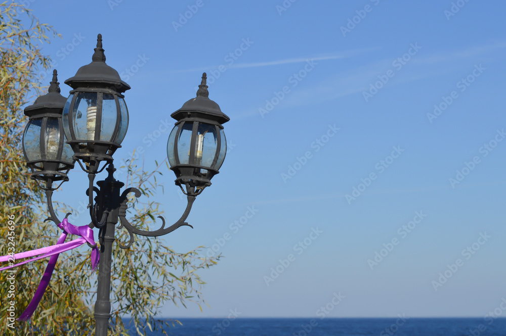 Lantern with water surface background on seashore on Kyiv Sea, autumn
