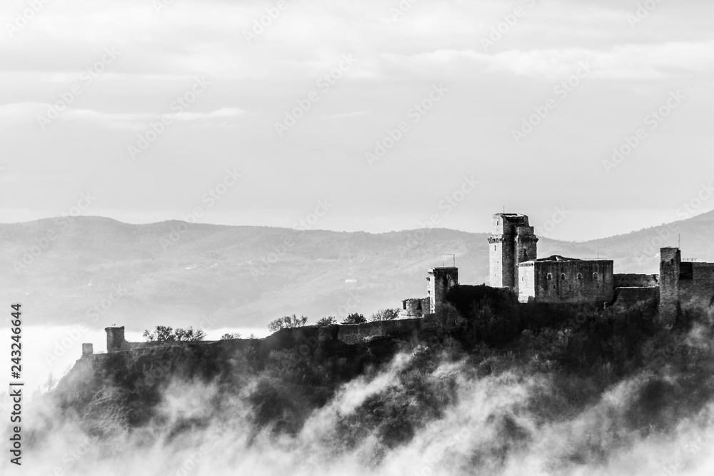 A view of Rocca Maggiore castle in Assisi (Umbria, Italy) in the middle of fog A view of Rocca Maggiore castle in Assisi (Umbria, Italy) in the middle of fog