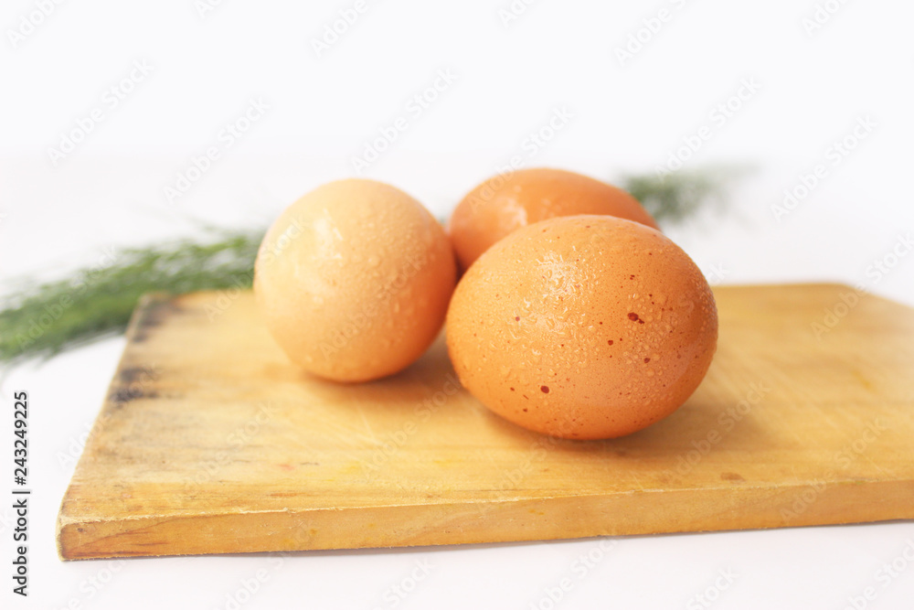 egg on a cutting board isolated on white 