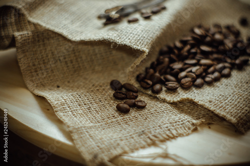 coffee beans and paper bag on wooden background