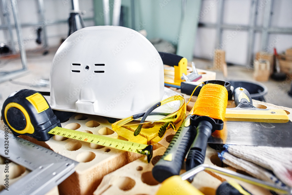 Fototapeta premium Home repairs. Construction tools, bricks and helmet