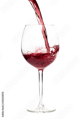 Beautiful splash of red wine in a glass on white background.