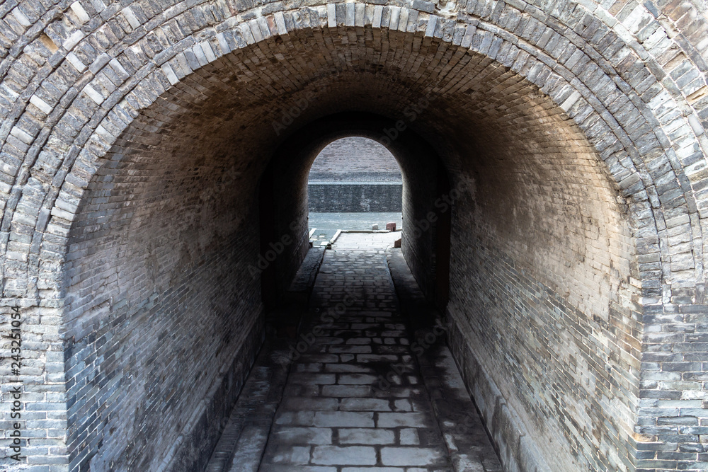 Fototapeta premium Arched entry in the ancient walls protecting the Old city of Pingyao, Shanxi province, China. Pingyao is a UNESCO World Heritage Site