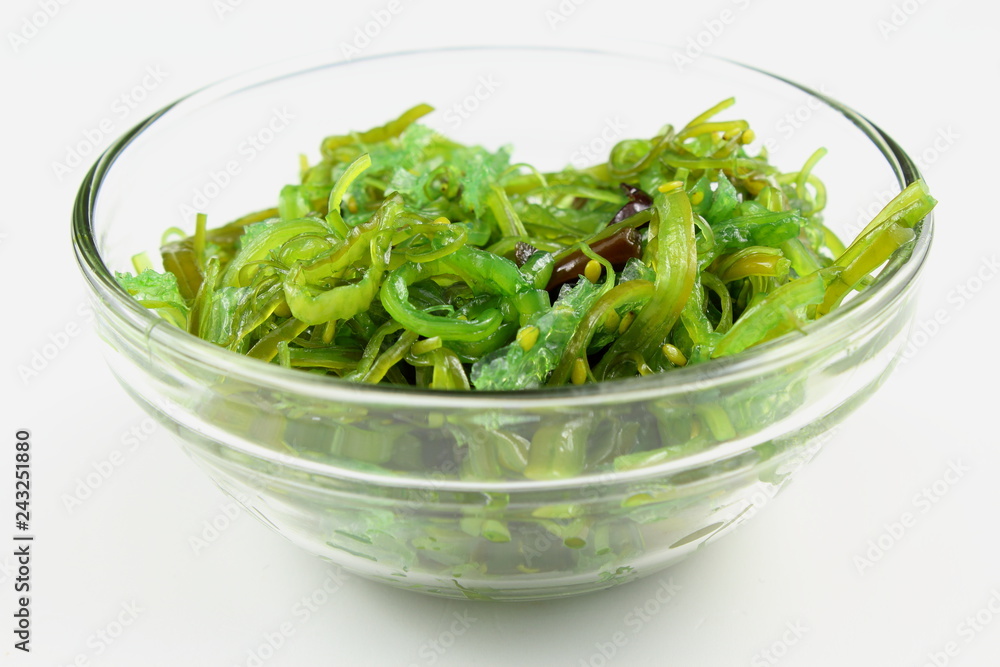 wakame salad with sesame in a small glass bowl isolated wakame salad with sesame in a small glass bowl isolated