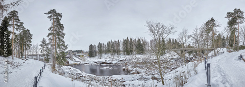 Finland Imatra River canyon cliffs and pine trees in winter