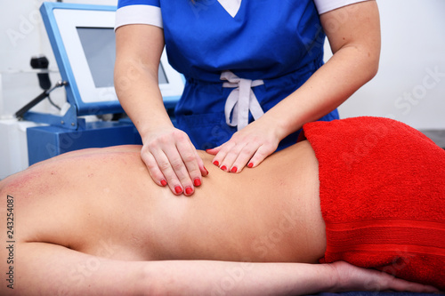 Anti-cellulite hand massage. Non surgical body sculpting. Anti-cellulite and anti-fat therapy in beauty salon. © ksu_ok