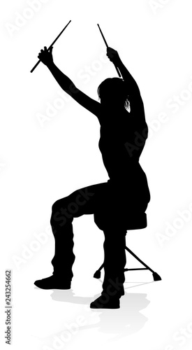 A drummer musician drumming drums in detailed silhouette
