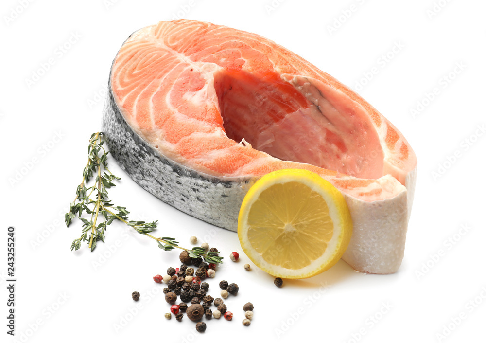 Piece of fresh salmon with spices on white background