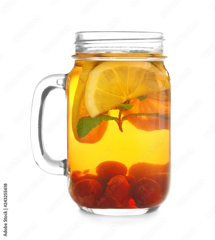 Mason jar of hot tea with lemon and berries on white background Mason jar of hot tea with lemon and berries on white background