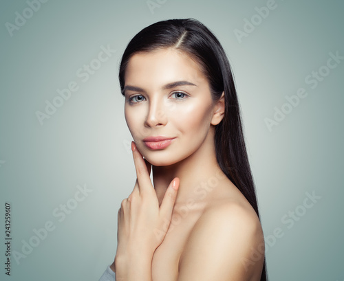 Cute young woman spa model with long hair and clear skin