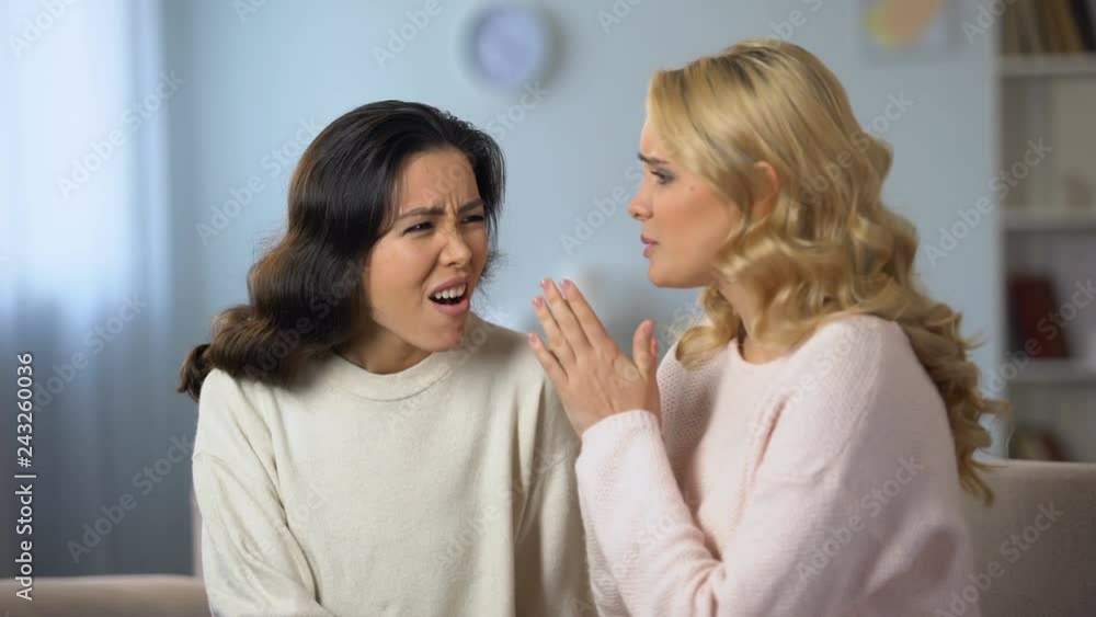Worried lady telling her best friend shocked news, private conversation at home Worried lady telling her best friend shocked news, private conversation at home