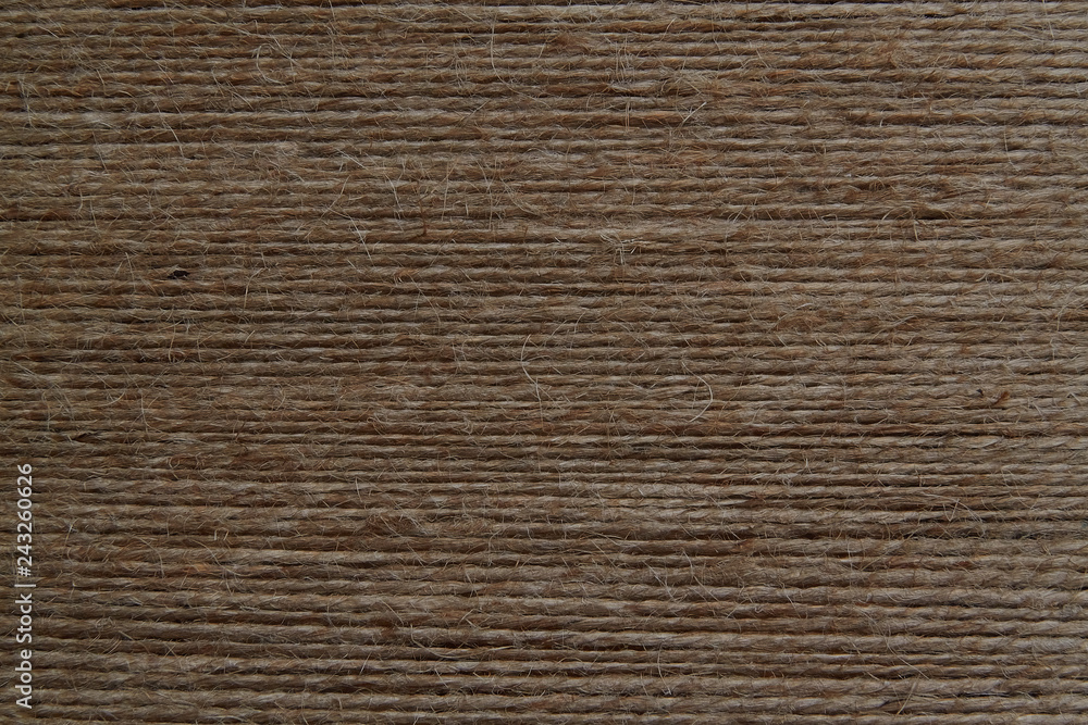 a lot of rough brown thread stretched parallel to each other a lot of rough brown thread stretched parallel to each other