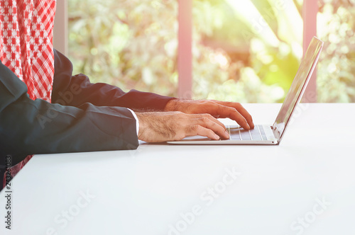 Arabian business man working on Laptop. photo