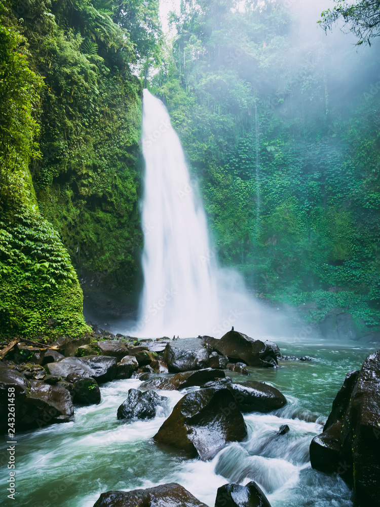 Powerful waterfall with fog. Tropical forest and Nung Nung waterfall
