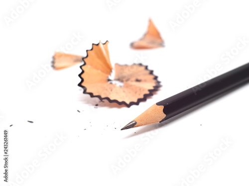Pencil with sharpening shavings on white background