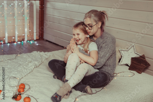 cozy photo session of two beautiful happy sisters in wooden house photo