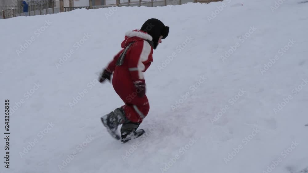 GOMEL, BELARUS - JANUARY 13, 2019: Winter fun. children ride from a snow hill. GOMEL, BELARUS - JANUARY 13, 2019: Winter fun. children ride from a snow hill.