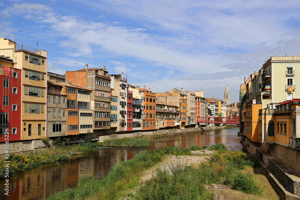 Colorful houses and Eiffel bridge on river Onyar in Girona