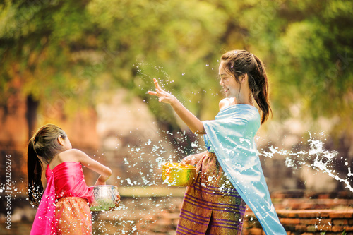 thai girls children playing water in songkran festival with thai period dress at ayutthaya in thailand