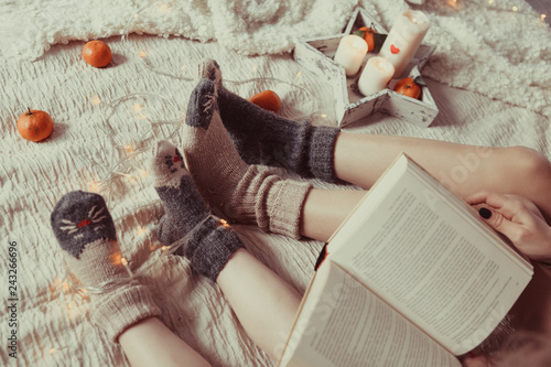 Two pairs of legs in knitted gray socks, photo in Hyugge style, photo