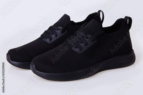 Textile summer shoes. Black slip-on shoes isolated on a white background. Urban skate shoes. Casual summer footwear. Sneakers