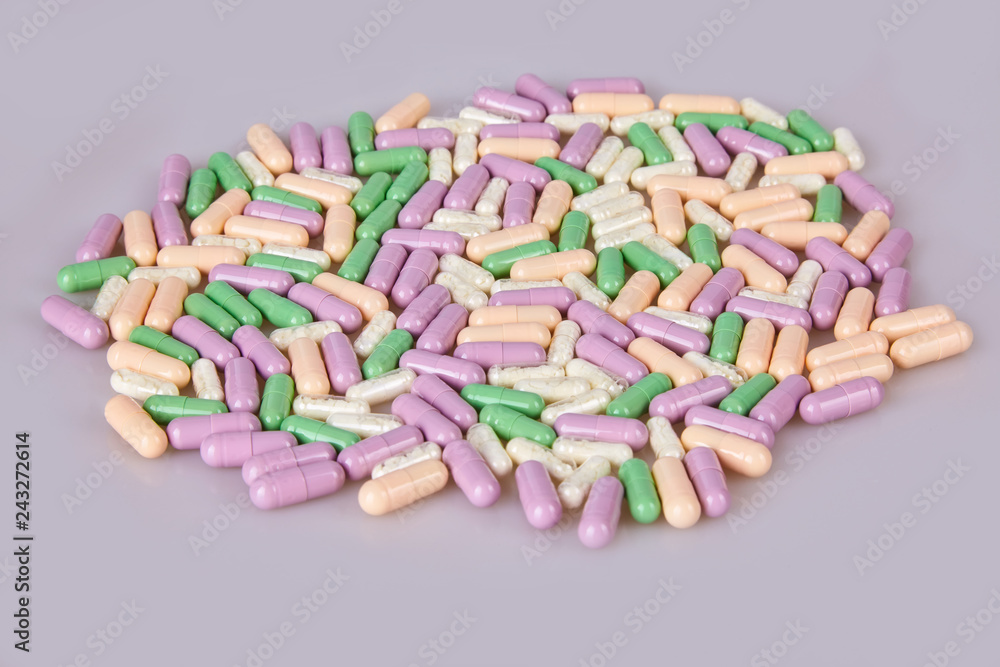 Spilled different capsules on the white background. Vitamin supplements tablets Spilled different capsules on the white background. Vitamin supplements tablets