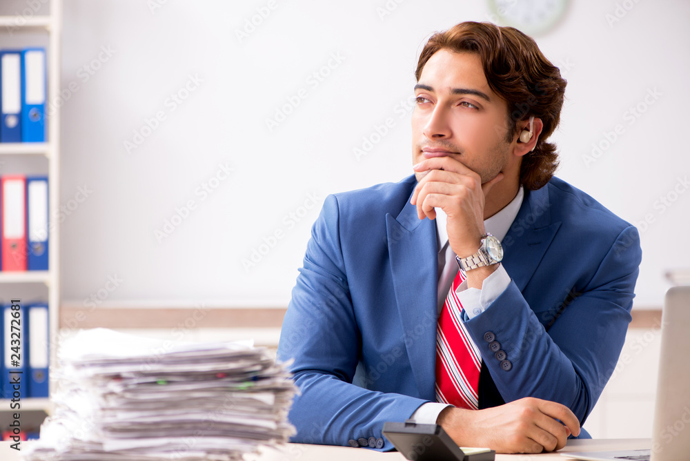 Deaf employee using hearing aid in office Deaf employee using hearing aid in office
