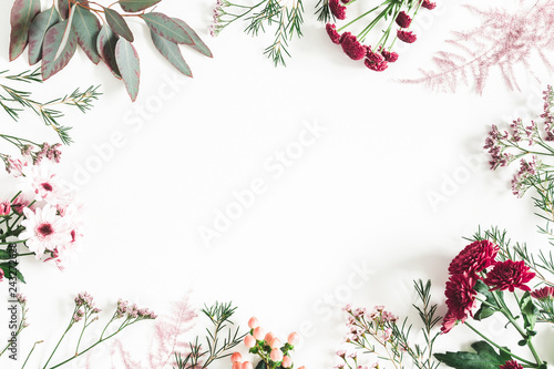 Flowers composition. Eucalyptus leaves and pink flowers on white background. Flat lay, top view