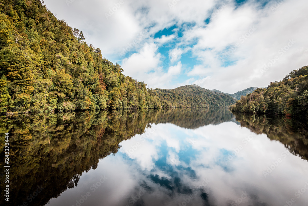 Natural reflections, mirror effect on the water in the beautiful wilderness of Tasmania, Gordon River near Strahan, Australia