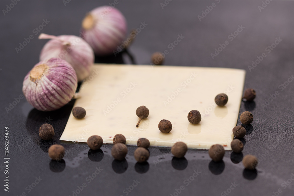 a piece of square cheese with garlic ,Processed cheese a piece of square cheese with garlic ,Processed cheese