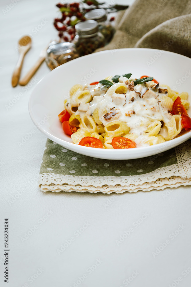 Cooked pasta with a cream sauce and roasted chicken cured with emmental. Cooked pasta with a cream sauce and roasted chicken cured with emmental.