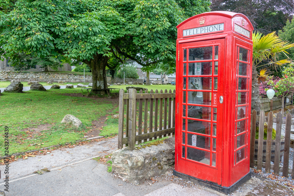 Red traditional english Phone booth in Widecombe in the Moor, Devon, UK Red traditional english Phone booth in Widecombe in the Moor, Devon, UK