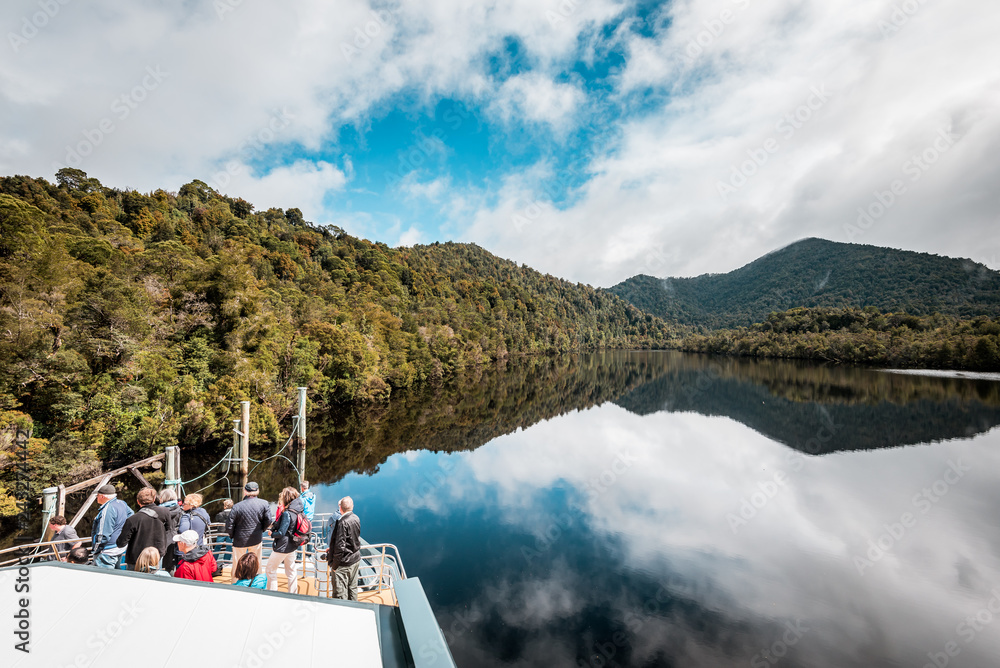 Tasmania, Australia on an Idyllic morning on the Gordon River, we'll take a cruise with great scenery and beautiful reflections in the water near the town of Strahan, on board of a highspeed catamaran