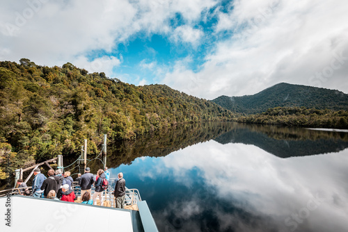 Obraz na płótnie Tasmania, Australia on an Idyllic morning on the Gordon River, we'll take a cruise with great scenery and beautiful reflections in the water near the town of Strahan, on board of a highspeed catamaran w salonie