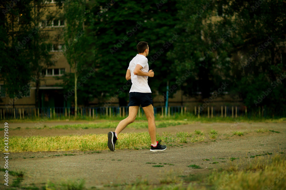 Athletic young man running in nature. Healthy lifestyle Athletic young man running in nature. Healthy lifestyle
