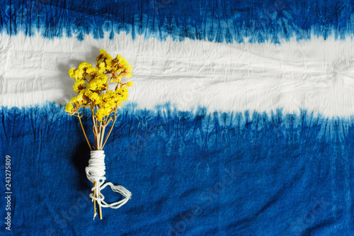 blue Indigo dyed cotton decorate with yellow flowers photo