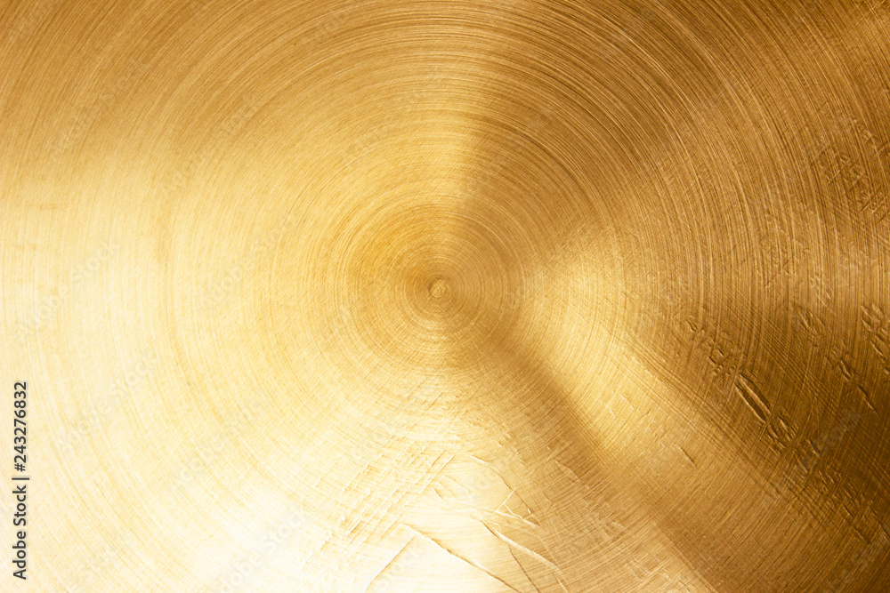 Fototapeta premium Abstract Gold polished metal brushed background or Shiny yellow leaf gold steel texture. Brushed metal plate with reflected light golden.