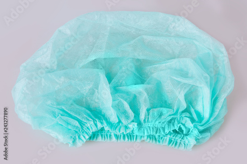 Green medical disposable cap isolated on white