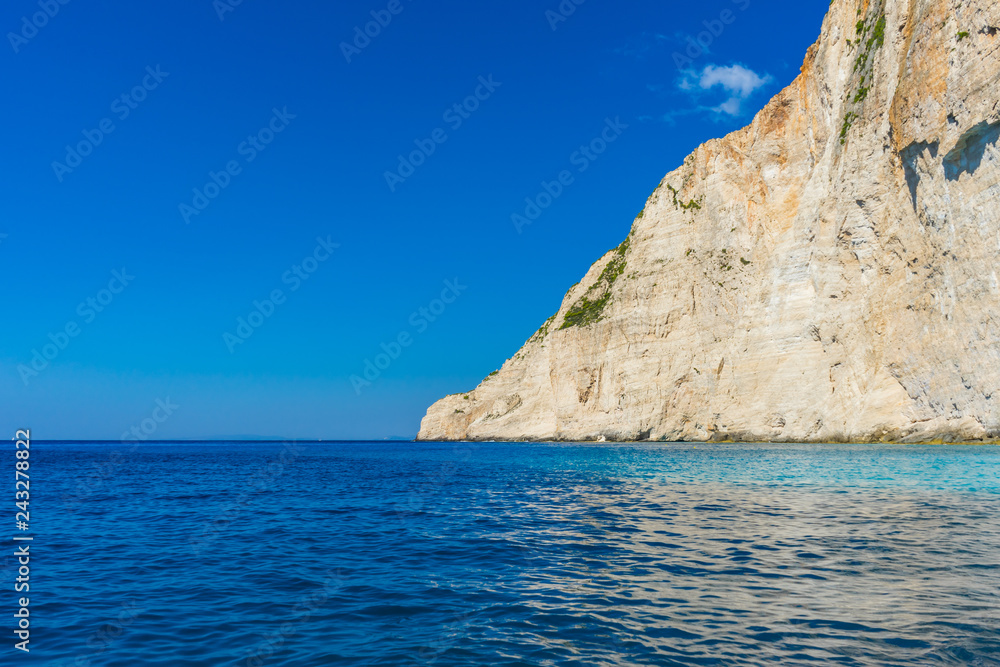 Greece, Zakynthos, Huge white cliff and beautiful blue ocean water at island coast