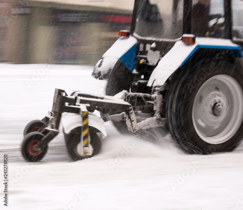 Fototapeta Naklejka Na Ścianę i Meble -  Snow removal machine cleaning the street from snow