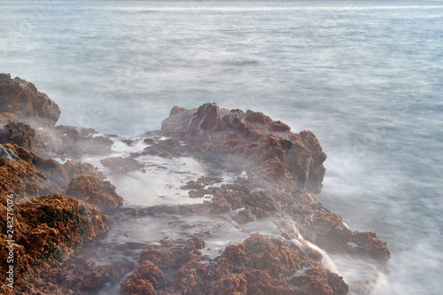 Waves break into shore.