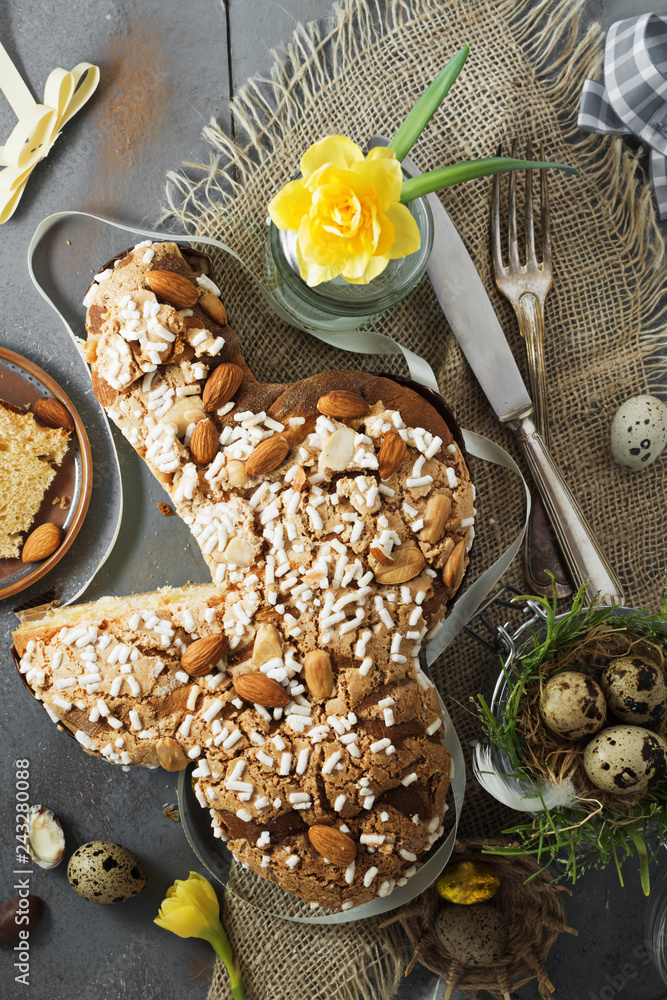 Fototapeta premium Colomba - italian easter dove cake on old rustic grey board. Selective focus, free text space.