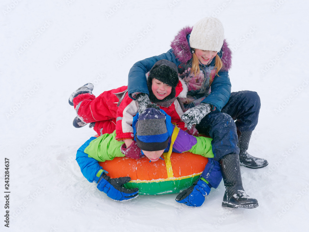 Winter fun. children ride from a snow hill. Winter fun. children ride from a snow hill.