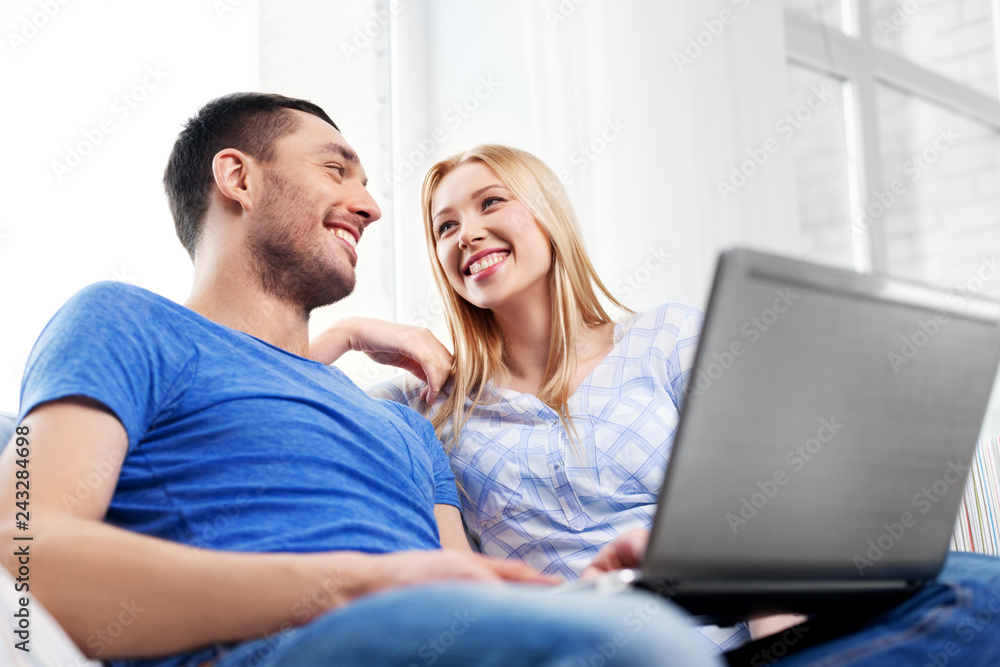 technology, internet and people concept - happy couple with laptop computer at home technology, internet and people concept - happy couple with laptop computer at home