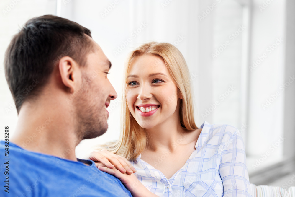 relationships and people concept - happy couple looking at each other at home relationships and people concept - happy couple looking at each other at home