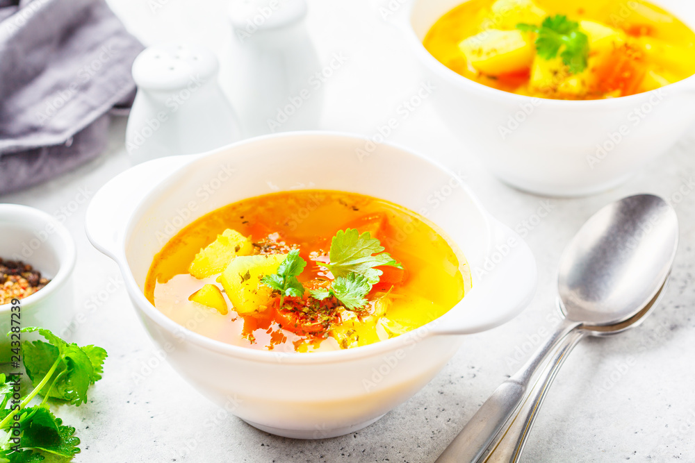 Vegetarian vegetable soup in bowls of white, white background.