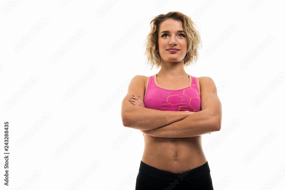 Low angle of beautiful young fit girl standing with arms crossed Low angle of beautiful young fit girl standing with arms crossed