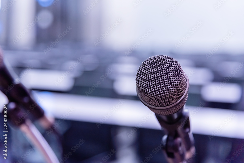 Microphone over the blurred business forum Meeting or Conference Training Learning Coaching Room Concept, Blurred background. Microphone over the blurred business forum Meeting or Conference Training Learning Coaching Room Concept, Blurred background.