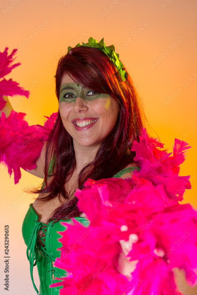 Carnaval Brazil. Face of latin redheaded girl with green make up mask. Bright background. Masquerade concept, celebration and festival.