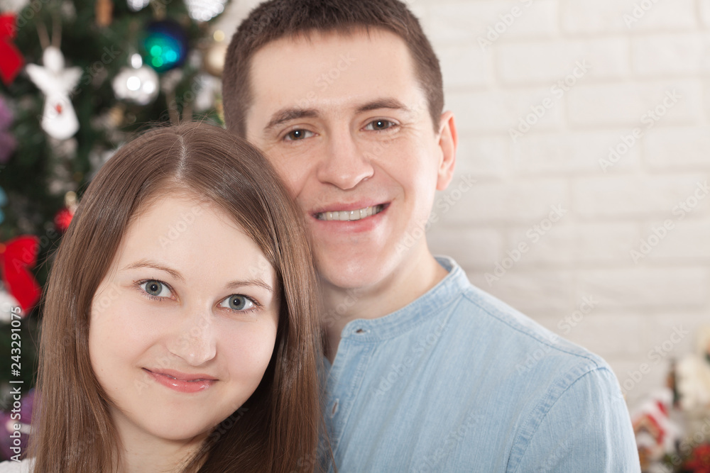 Cheerful couple holding hands enjoying together on Christmas eve. Christmas time at home